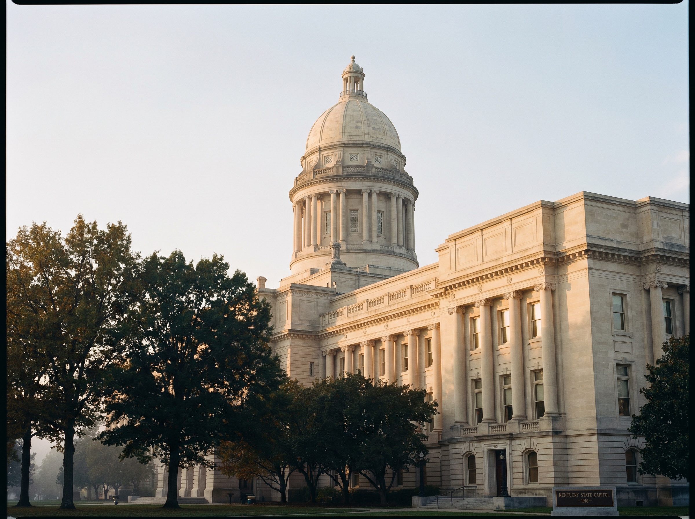 The Kentucky State Capitol in Frankfort at golden hour, dignified institutional architecture.